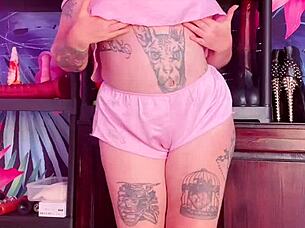 Silk clad MILF show off her curves and tempt with her tattoos.
