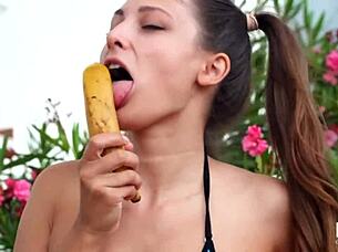 Tiny Talia Mint in hot erotic action with a banana