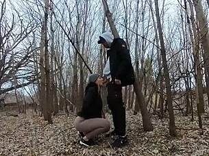Big boobed woman gives a blow job in a public place
