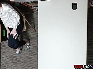 A police officer arrests a red-haired teenage girl for shoplifting in a mall