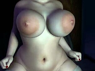 A mature woman with an hourglass shape has sex with a sex toy on the bed
