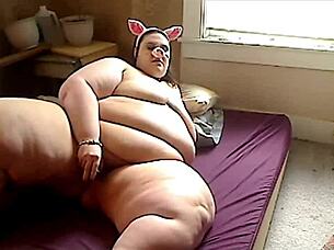 A plus size woman in a pig onesie and fishnet stockings has a solo pleasure experience