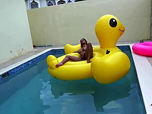 Maxine X plays with her pussy while sunbathing in the pool