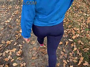 The juicy ass of a charming milf in tight pants from the back