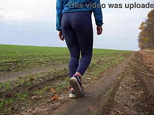 The juicy ass of a charming milf in tight pants from the back