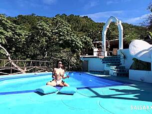 Latina with a tattoo is having fun by the pool, getting wild
