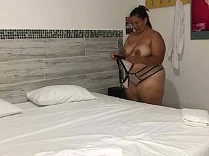 Colombian neighbor enjoys bedroom fun with big tits and squirting action.