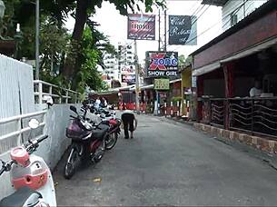 Asian tourist check out sex district in Thailand
