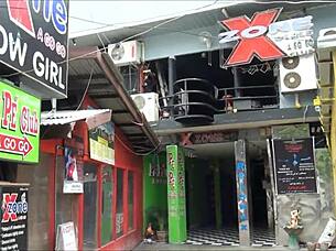 Asian tourist check out sex district in Thailand