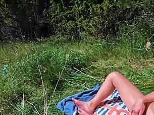 Out door young girl pleasures herself and reaches climax