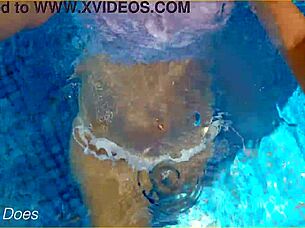Flashy voyeur video of a MILF swimming in a hotel pool in her transparent shirt