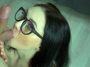 A woman is watching her partner give her a blowjob and just as give her a mouthful of semen