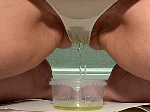 MILF voluptuous blonde takes in the piss in her tight white pants